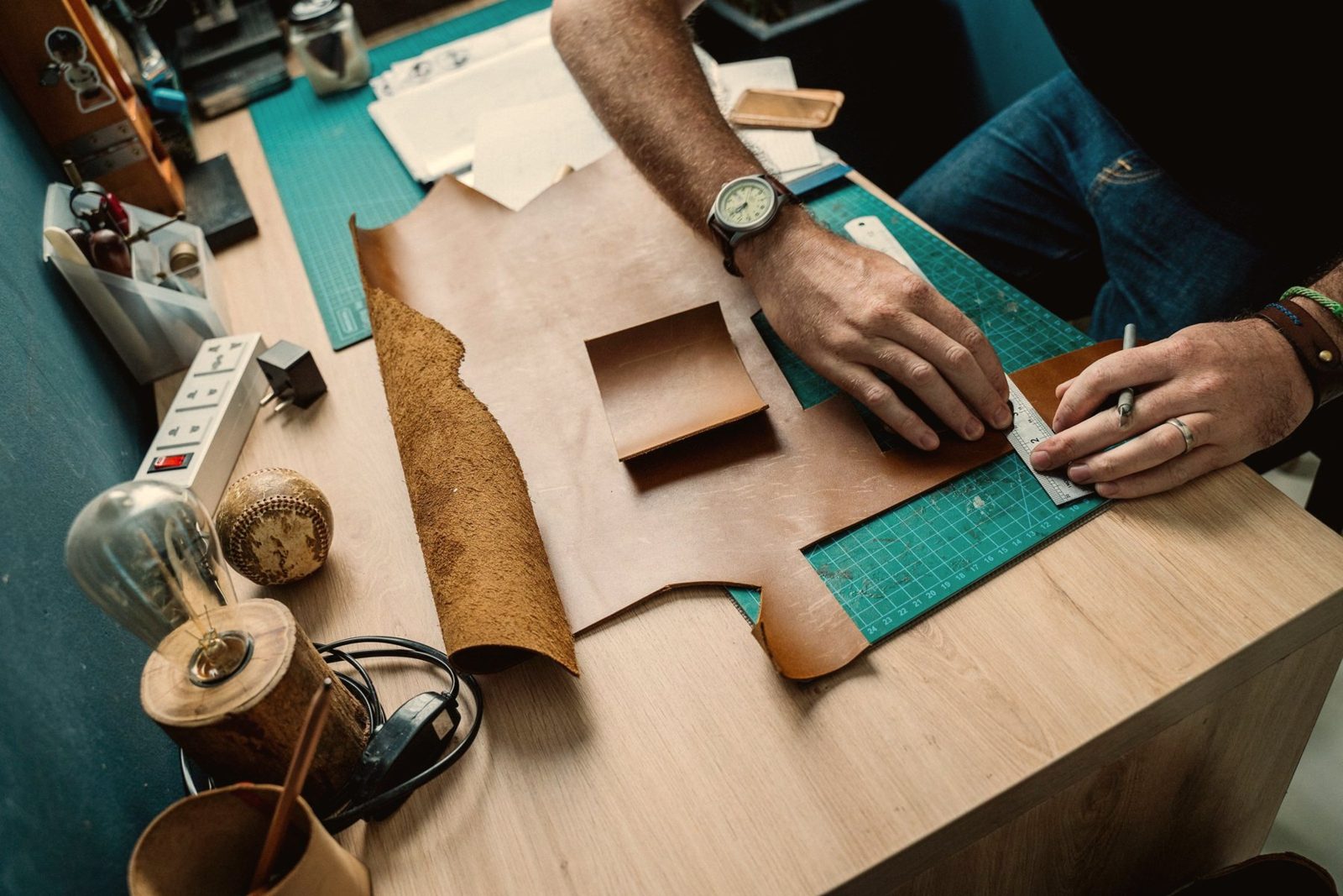 Craftspeople stitching leather bags