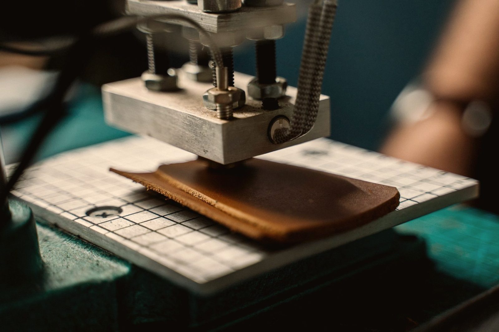 Craftspeople stitching leather bags